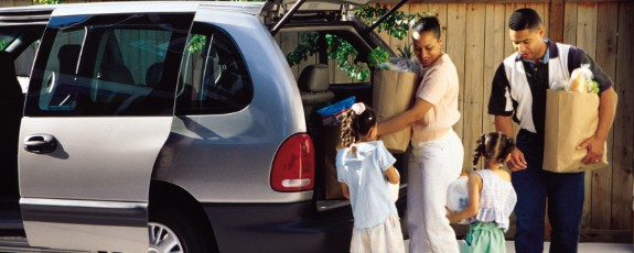 Family taking groceries out of the van